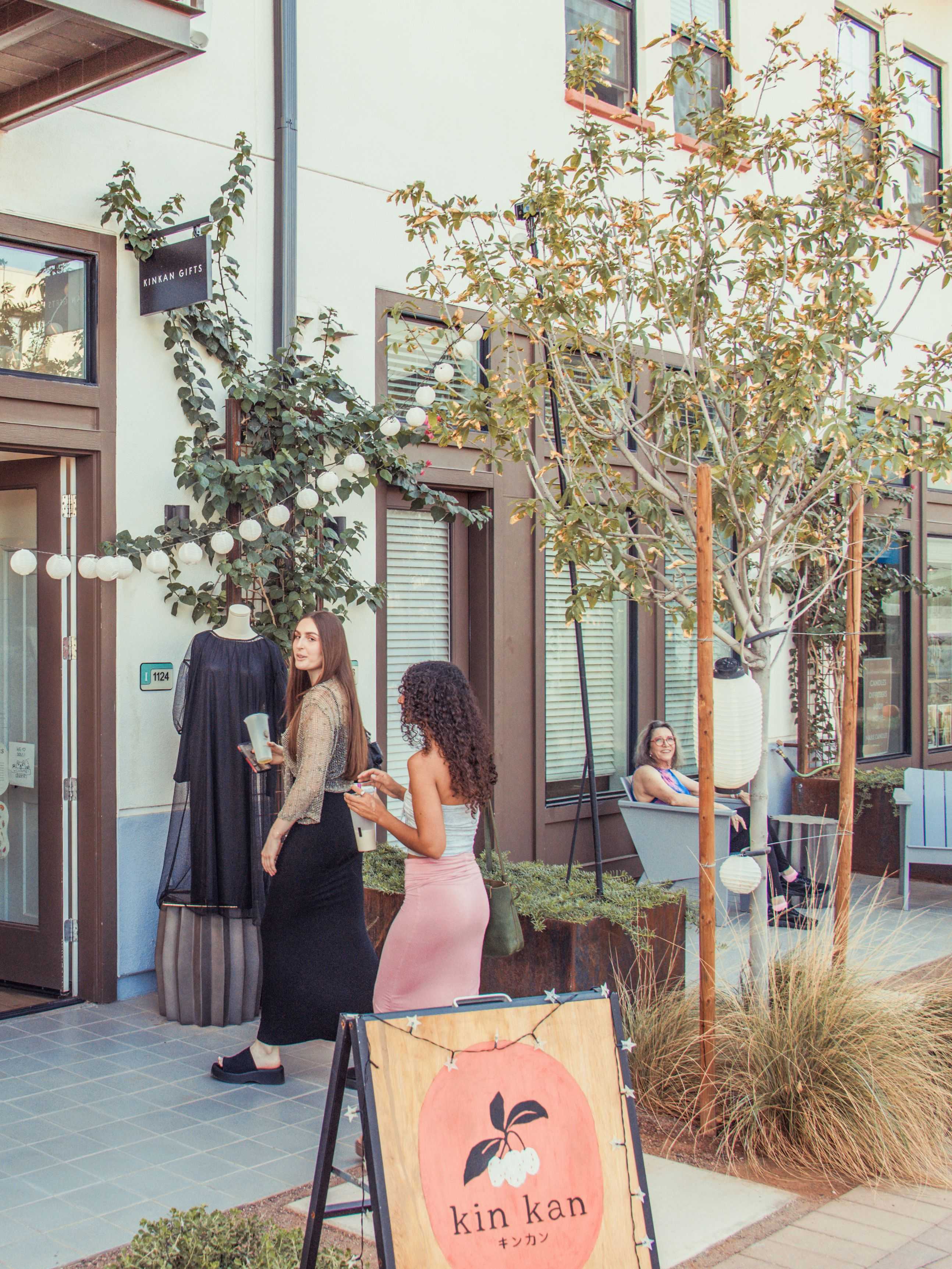 Customers chatting outside Kin Kan gift shop